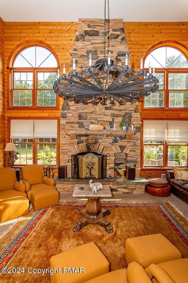 295 Hty Rd, Kunkletown, PA 18058 - carpeted living room with a high ceiling, wooden walls, a fireplace, and a chandelier
