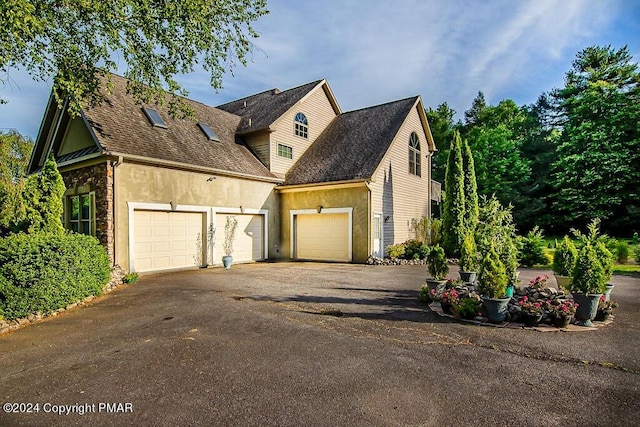 295 Hty Rd, Kunkletown, PA 18058 - view of front of home featuring a garage, asphalt driveway, and stucco siding