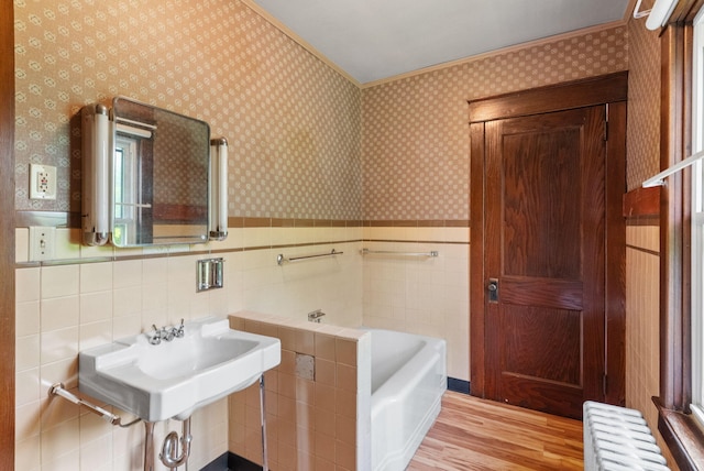 100 Mahoning Dr E, Lehighton, PA 18235 - bathroom with wood finished floors, a bathtub, wallpapered walls, wainscoting, and radiator