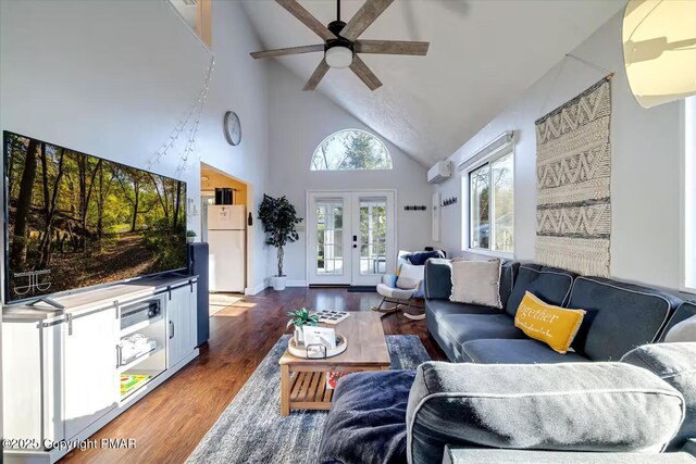 living room featuring high vaulted ceiling, french doors, wood finished floors, and a ceiling fan