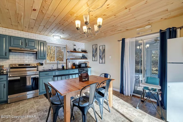 kitchen with under cabinet range hood, wood ceiling, freestanding refrigerator, stainless steel electric range oven, and dark countertops