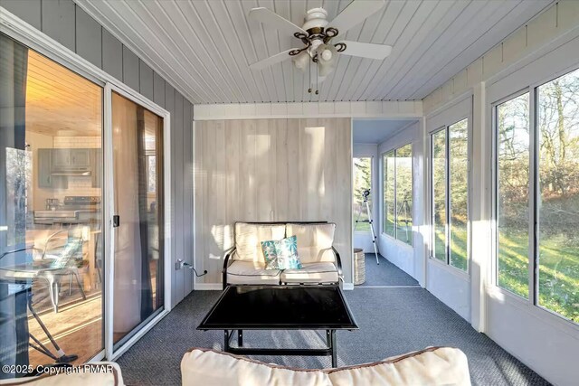 sunroom featuring wooden ceiling and ceiling fan