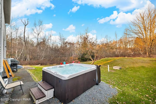 view of pool featuring area for grilling, a lawn, and a hot tub