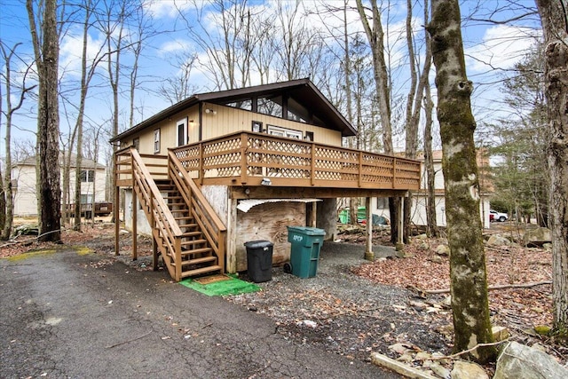 view of outbuilding with driveway and stairs