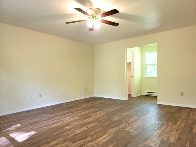 1169 Hunters Woods Dr, East Stroudsburg, PA 18301 - spare room featuring a baseboard heating unit, ceiling fan, dark wood finished floors, and baseboards