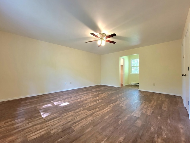 1169 Hunters Woods Dr, East Stroudsburg, PA 18301 - spare room featuring baseboard heating, ceiling fan, dark wood-style floors, and baseboards
