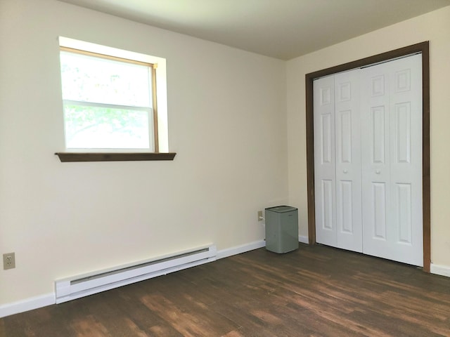 1169 Hunters Woods Dr, East Stroudsburg, PA 18301 - unfurnished bedroom with a baseboard heating unit, dark wood-type flooring, baseboards, and a closet
