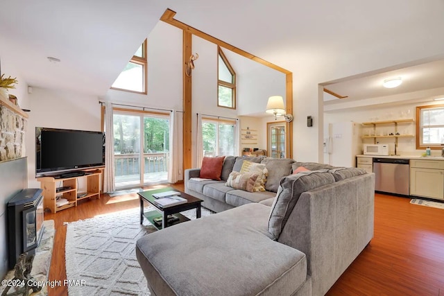 living area featuring light wood-style flooring and a high ceiling