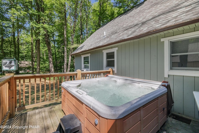 wooden deck with a hot tub