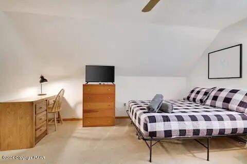 bedroom featuring lofted ceiling, ceiling fan, and baseboards