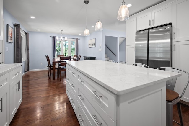 4169 Hemlock Trl, Pocono Pines, PA 18350 - kitchen with freestanding refrigerator, a breakfast bar, recessed lighting, a center island, and dark wood-style flooring