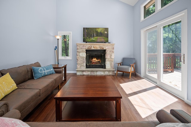 4169 Hemlock Trl, Pocono Pines, PA 18350 - living room with wood finished floors, a fireplace, and high vaulted ceiling