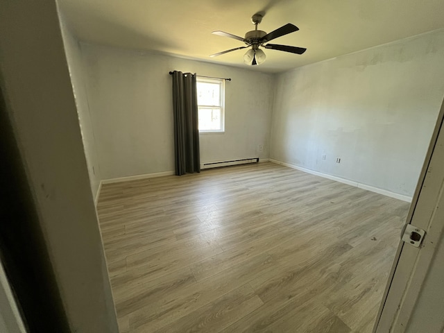 1227 Alder Rd, East Stroudsburg, PA 18302 - empty room featuring baseboard heating, baseboards, ceiling fan, and light wood finished floors