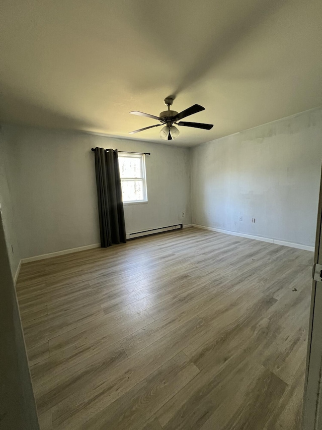 1227 Alder Rd, East Stroudsburg, PA 18302 - unfurnished room with wood finished floors, ceiling fan, a baseboard heating unit, and baseboards