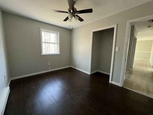 1227 Alder Rd, East Stroudsburg, PA 18302 - unfurnished bedroom with baseboard heating, baseboards, wood finished floors, and a ceiling fan