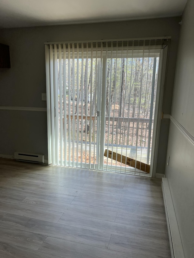 1227 Alder Rd, East Stroudsburg, PA 18302 - unfurnished dining area featuring a baseboard heating unit and wood finished floors