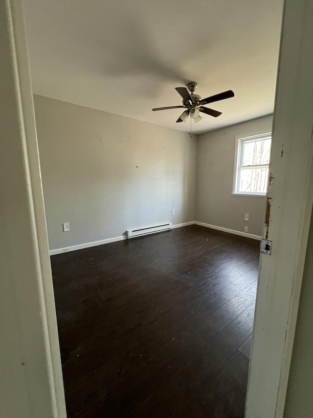 1227 Alder Rd, East Stroudsburg, PA 18302 - empty room featuring baseboards, baseboard heating, a ceiling fan, and dark wood finished floors