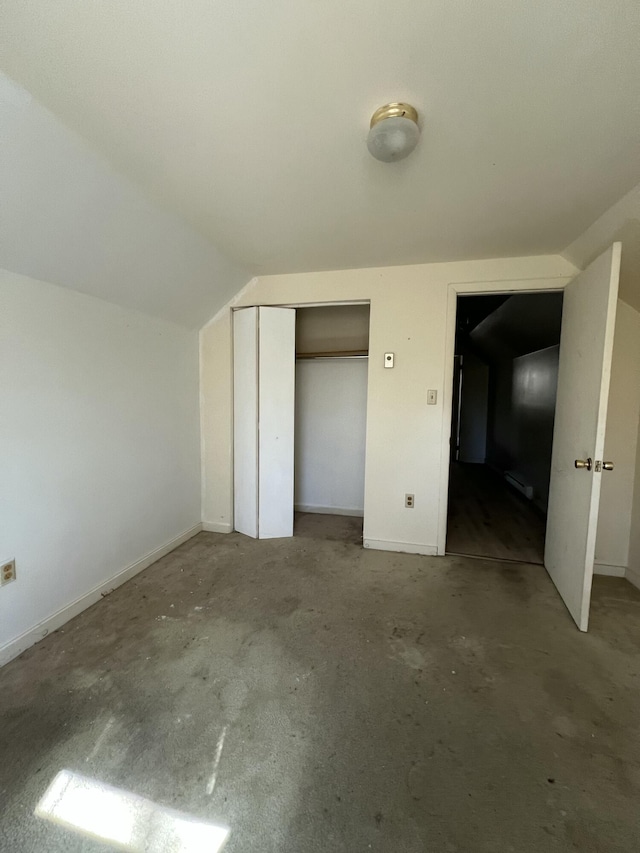 1227 Alder Rd, East Stroudsburg, PA 18302 - unfurnished bedroom with a closet, unfinished concrete flooring, lofted ceiling, and baseboards