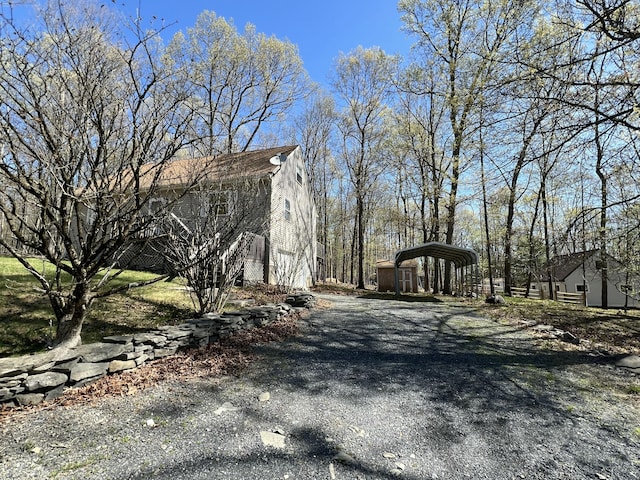 1227 Alder Rd, East Stroudsburg, PA 18302 - view of side of home featuring a carport and aphalt driveway