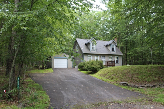 5147 Arrowhead Ln, East Stroudsburg, PA 18302 - new england style home featuring driveway, a chimney, an outbuilding, a detached garage, and a shingled roof