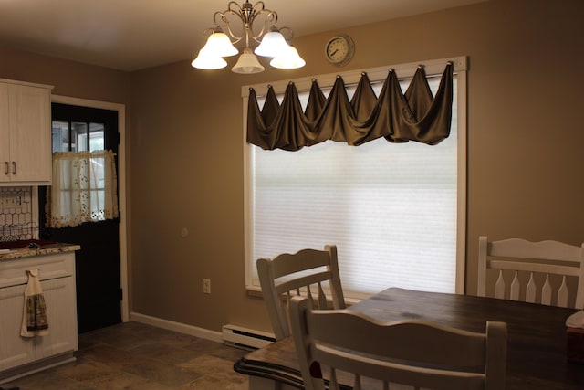 5147 Arrowhead Ln, East Stroudsburg, PA 18302 - dining area with a baseboard heating unit, a chandelier, and dark stone finish flooring