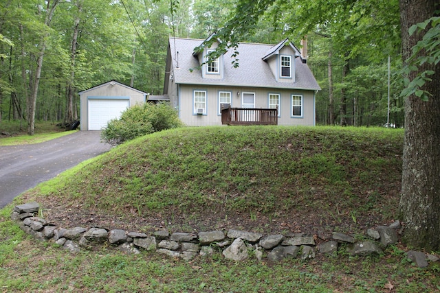 5147 Arrowhead Ln, East Stroudsburg, PA 18302 - cape cod home featuring an outdoor structure, a chimney, a detached garage, a deck, and a shingled roof
