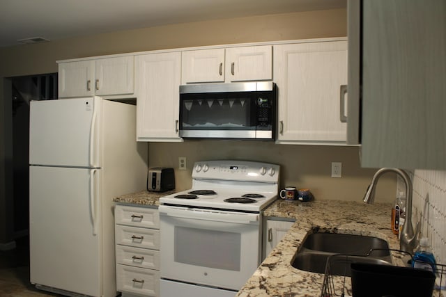 5147 Arrowhead Ln, East Stroudsburg, PA 18302 - kitchen with white appliances, white cabinetry, and light stone countertops
