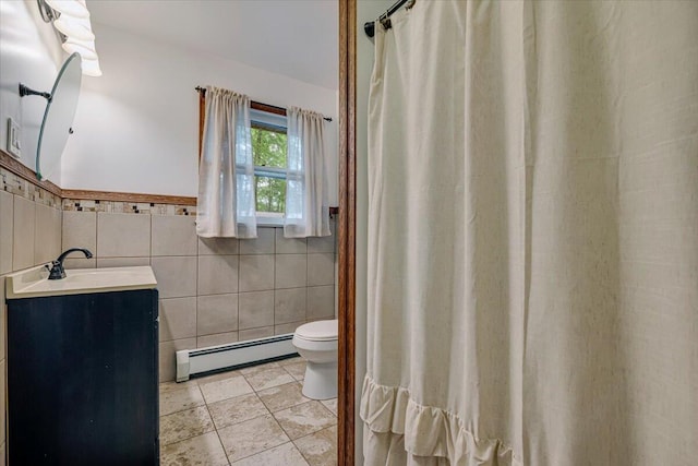 275 Selig Rd, Pocono Lake, PA 18347 - bathroom featuring a baseboard heating unit, tile walls, vanity, and a wainscoted wall