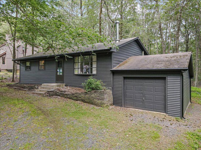 275 Selig Rd, Pocono Lake, PA 18347 - view of front of house featuring a garage, driveway, and roof with shingles