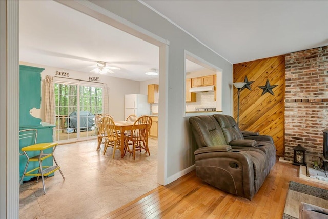 275 Selig Rd, Pocono Lake, PA 18347 - living area featuring wooden walls, ceiling fan, light wood-style floors, and a wood stove