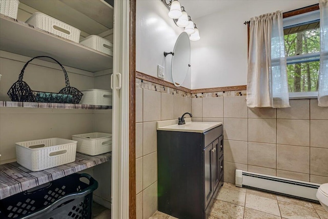 275 Selig Rd, Pocono Lake, PA 18347 - bathroom with a baseboard heating unit, tile walls, vanity, and a wainscoted wall