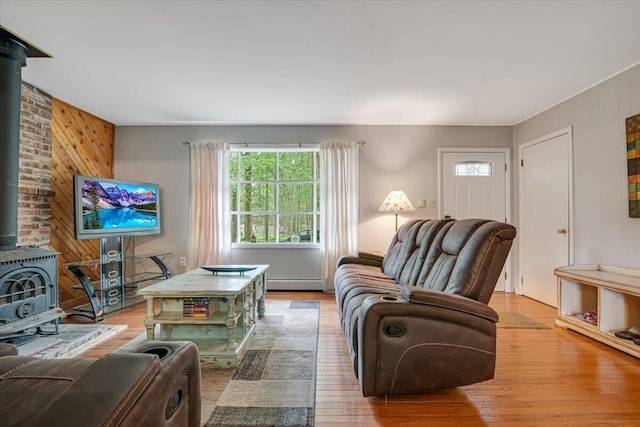 275 Selig Rd, Pocono Lake, PA 18347 - living area with a wood stove, plenty of natural light, baseboard heating, wood finished floors, and wooden walls