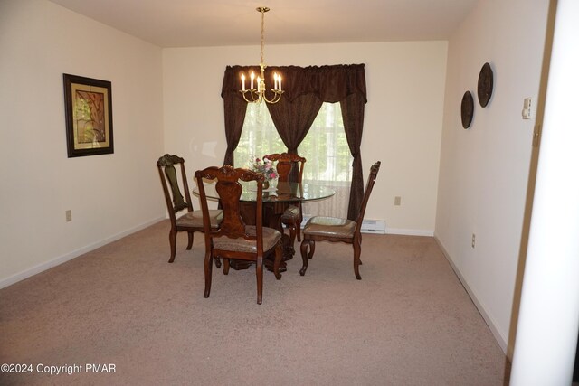 carpeted dining area featuring a baseboard heating unit, baseboards, and a chandelier