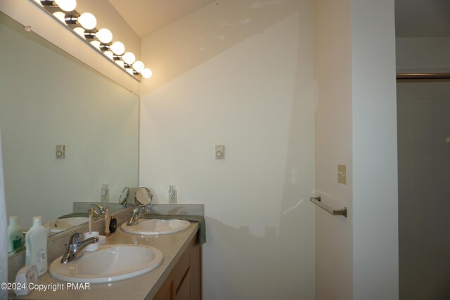 bathroom with a sink and double vanity