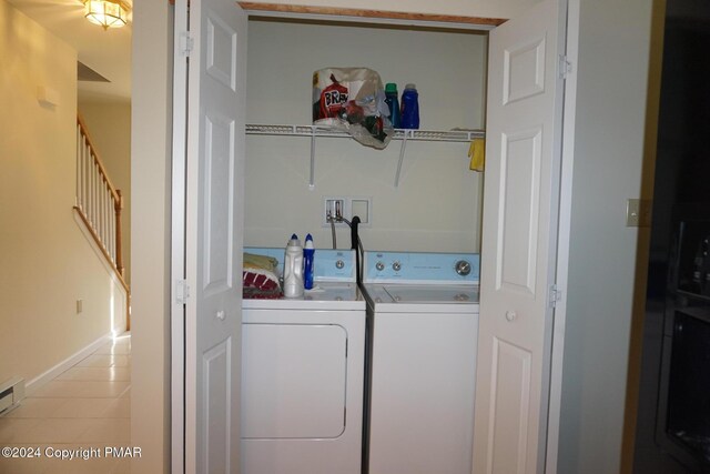 washroom with laundry area, light tile patterned floors, and washer and clothes dryer