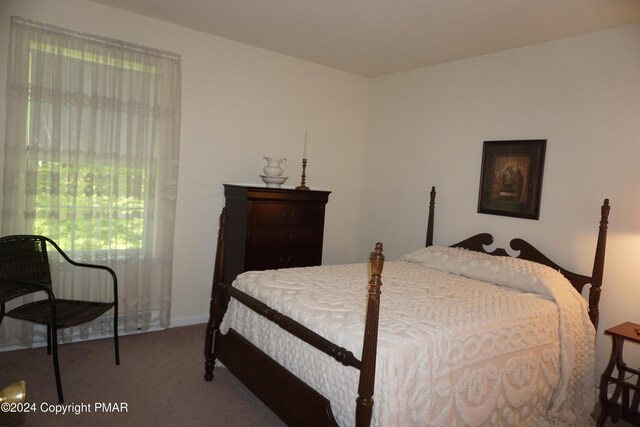 carpeted bedroom with baseboards