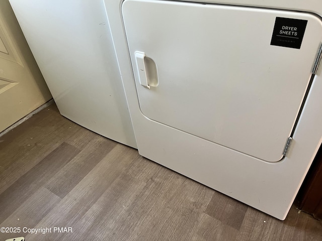 room details with washer / dryer and wood finished floors