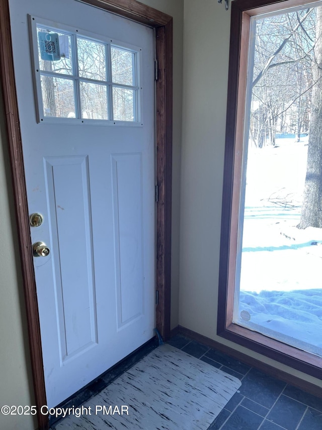 doorway featuring dark tile patterned flooring