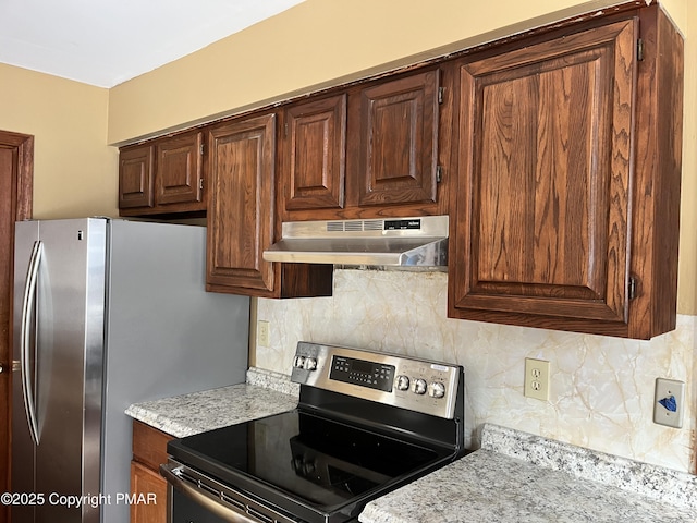 kitchen with backsplash, under cabinet range hood, and stainless steel appliances