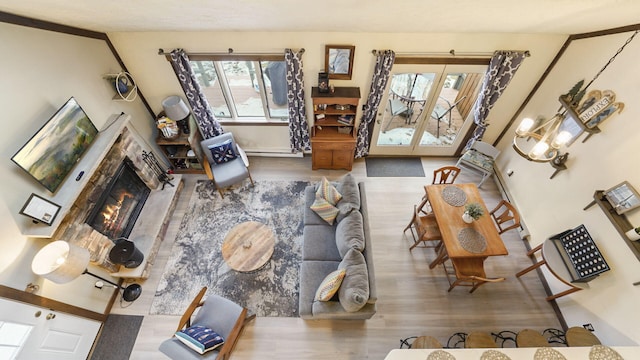 living room featuring wood finished floors and a warm lit fireplace