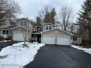 view of front of home featuring aphalt driveway and an attached garage