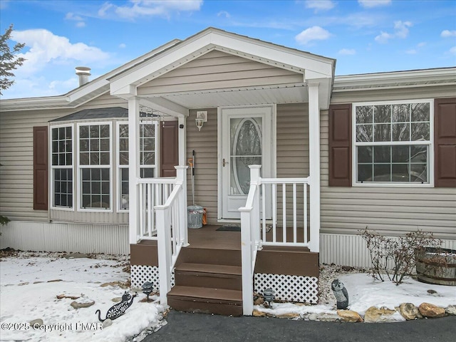 view of snow covered property entrance