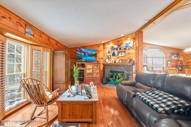 living area with lofted ceiling, wood walls, and hardwood / wood-style flooring