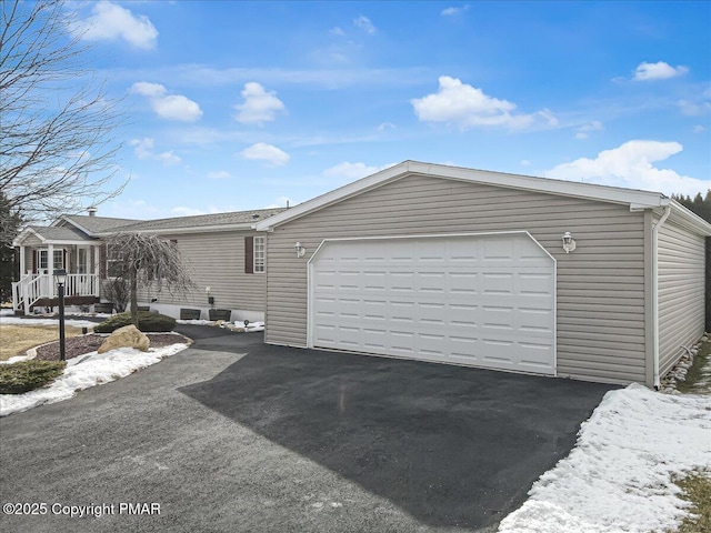 view of front facade with aphalt driveway and a garage