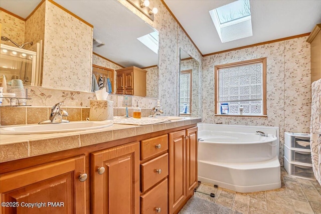 full bath with wallpapered walls, vaulted ceiling with skylight, ornamental molding, and a sink