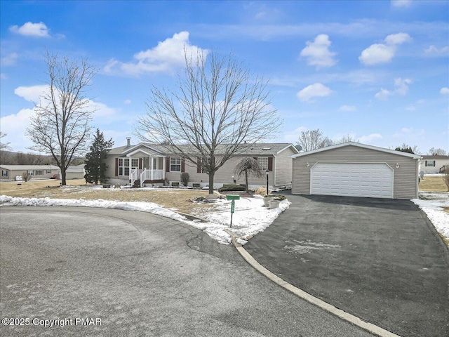 view of front of home featuring a detached garage and an outbuilding