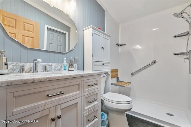 full bathroom featuring toilet, a stall shower, and vanity