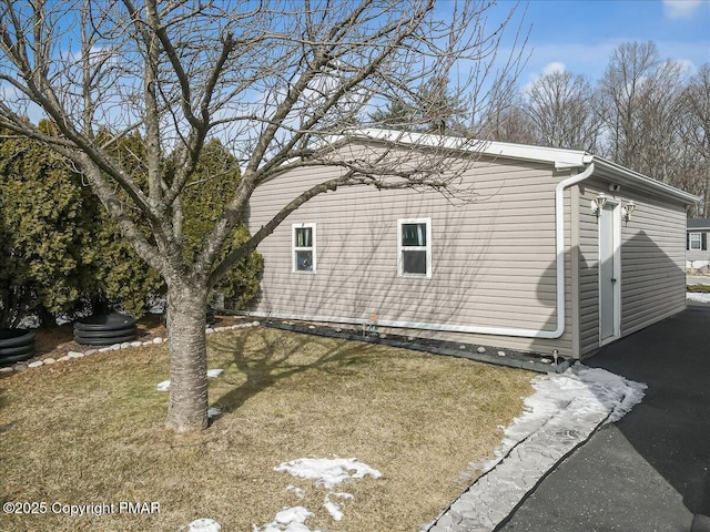 view of side of property with a yard