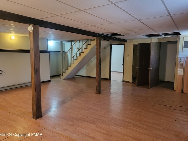 2153 Gravel Rd, Canadensis, PA 18325 - finished basement featuring a baseboard heating unit, light wood finished floors, stairway, and a paneled ceiling