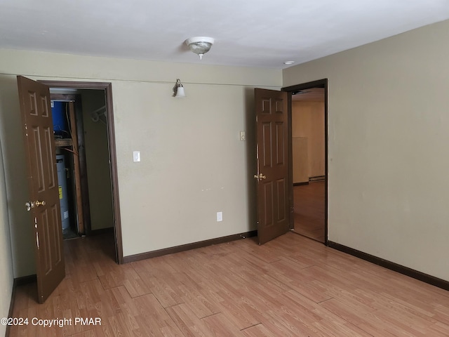 2153 Gravel Rd, Canadensis, PA 18325 - spare room featuring water heater, baseboards, and light wood-style floors